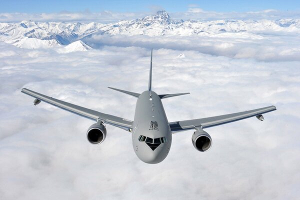 A Boeing transport plane flies over the wreckage