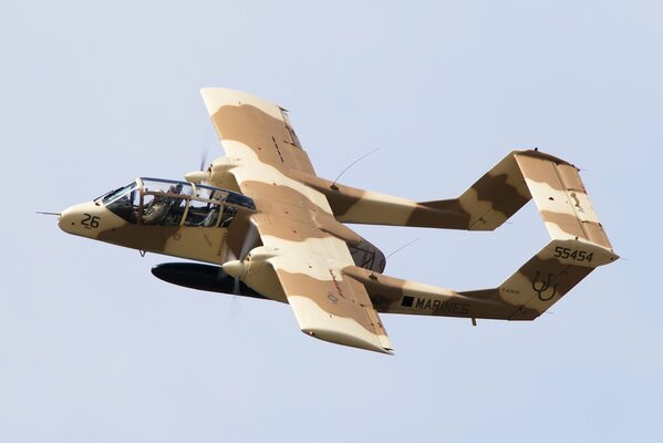 The ov-10 bronco attack aircraft flies in the sky during the day