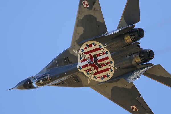 The mig-29a multi-purpose fighter performs a maneuver in the sky