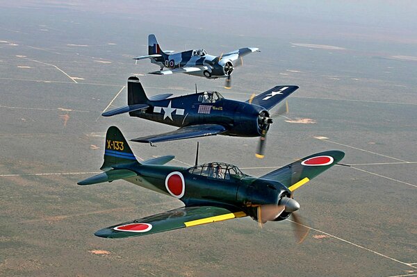 Three planes are flying over the fields