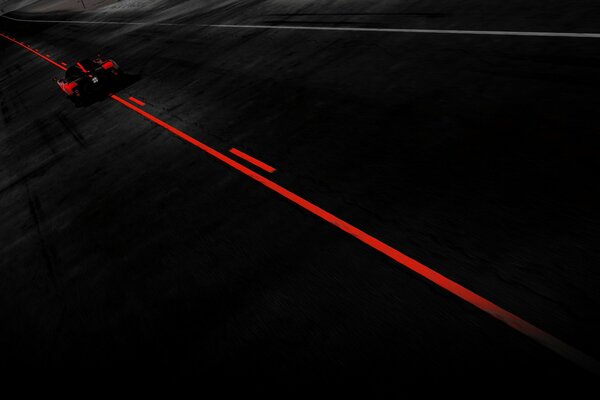 In the darkness of the night, the racing car picks up speed