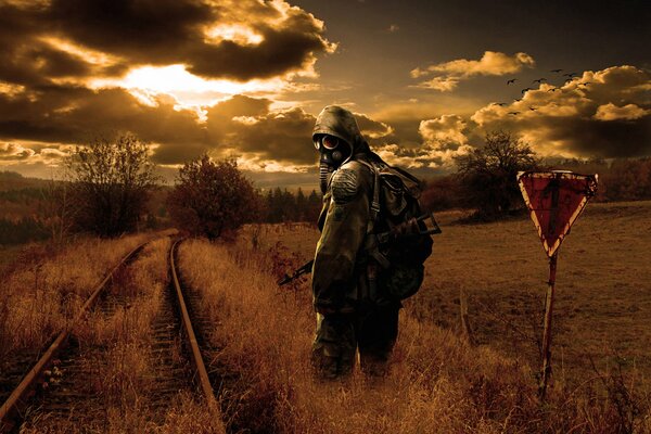 Stalker goes into the sunset against the background of the exclusion zone