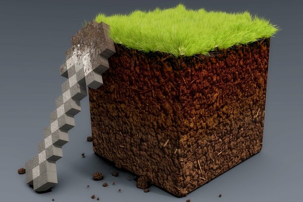 Mini shovel with a piece of earth and grass