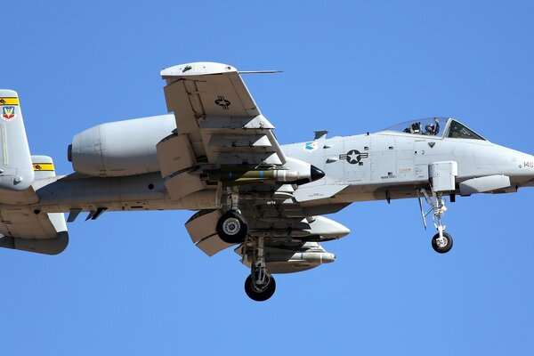 Military aircraft with ammunition on a blue sky background