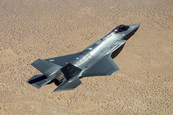 Lockheed Martin fighter flying over the ground