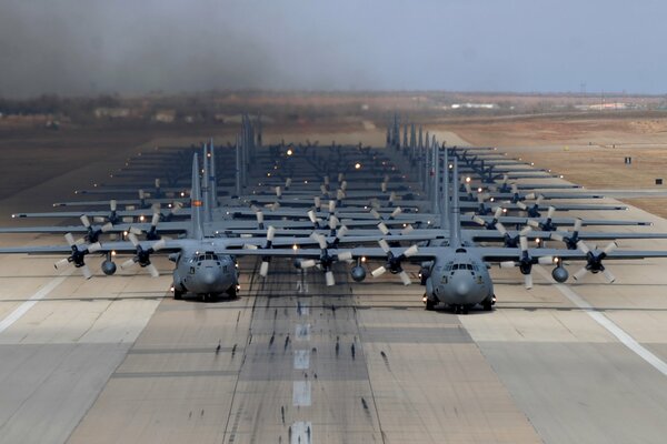 Military transport planes one after another on the runway