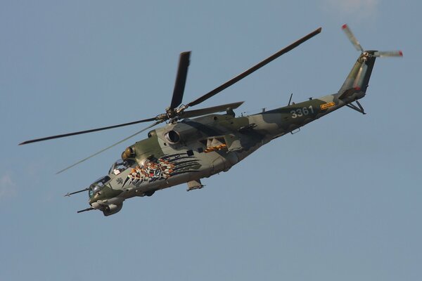 The Mi-35 is flying on a combat mission in the blue sky. 