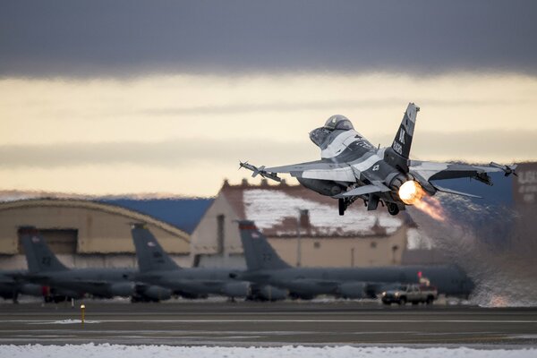 A fighter plane taking off from a military base