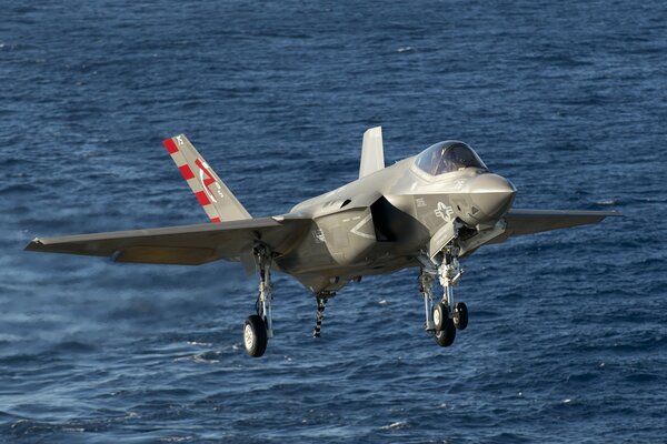 Fighter-bomber takes off over the sea