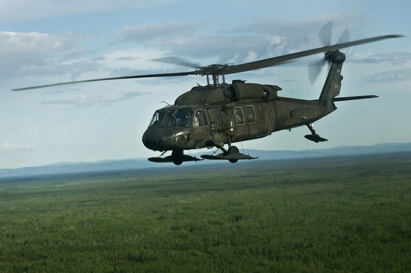 Helicopter in flight over the forest