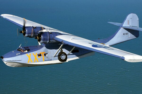 A beautiful seaplane is flying over the sea