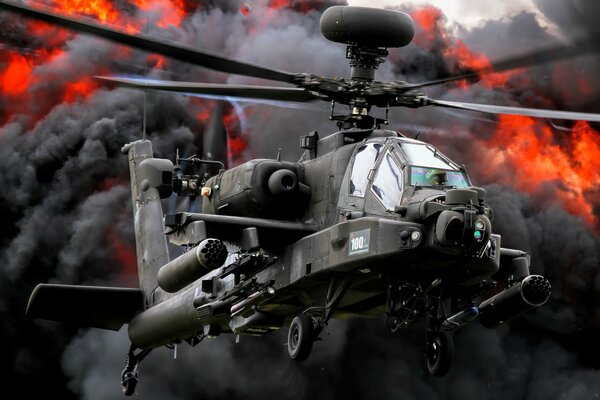 Apache attack helicopter on the background of fire and smoke