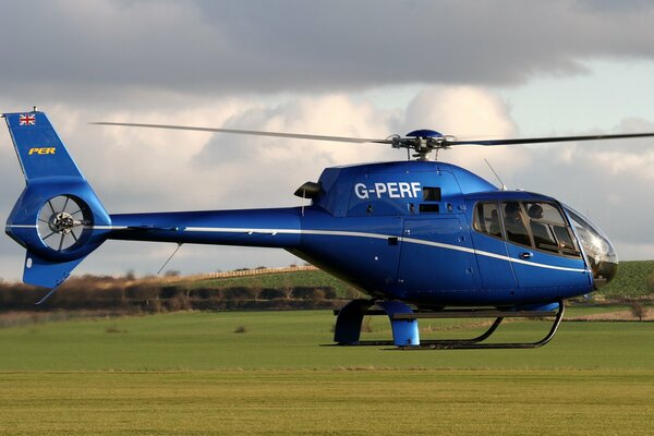 Multipurpose light helicopter EC120B on the green lawn