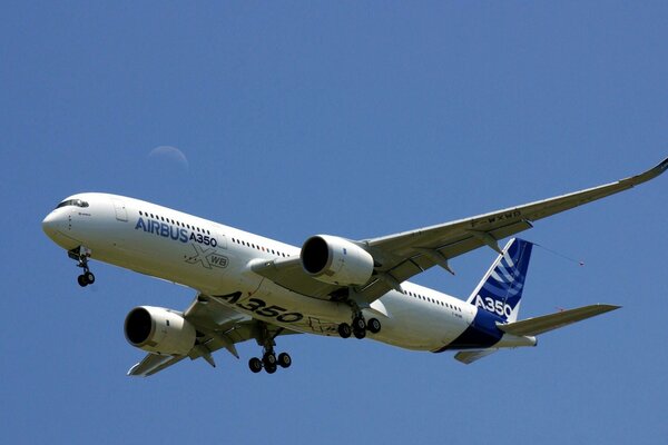 A large airbus A350-900 flies in the blue sky