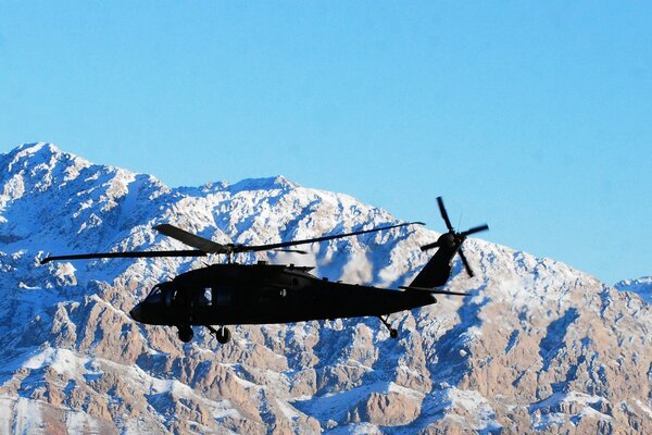 Helicopter landing on snowy mountains