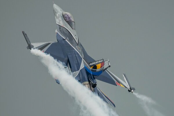 A fighter plane is flying on a gray background