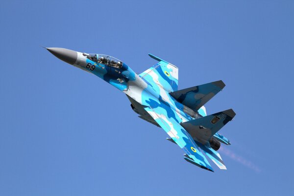 SU-27 fighter jet blue camouflage paint, flying in the sky