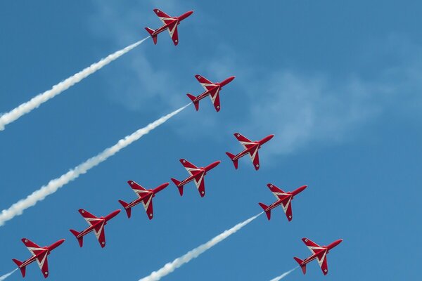 Nueve aviones rojos en el cielo volando