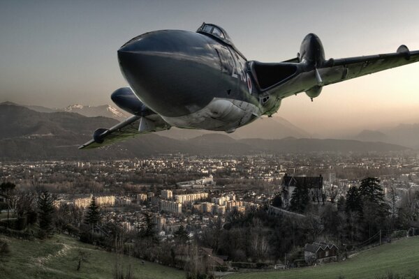 A military fighter jet flies over a big city