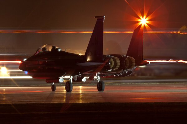 The plane is preparing to take off from the airfield at night