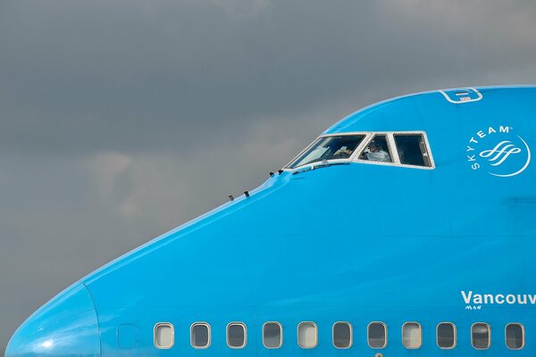 The cockpit is visible from the blue plane