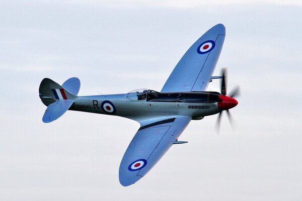 Blue British ww2 fighter in the sky