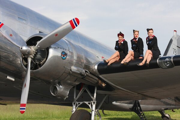 Funny flight attendants on the wing of the plane