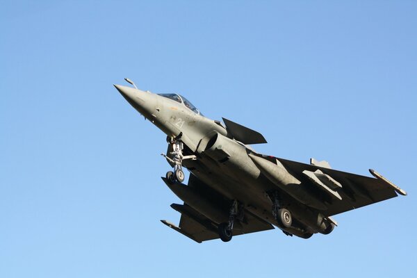 Multi-purpose fighter Dassault Rafale in monotonous coloring against the sky.