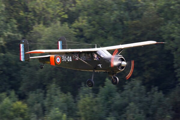 Transport and communication aircraft mh. 1521 on the background of the forest