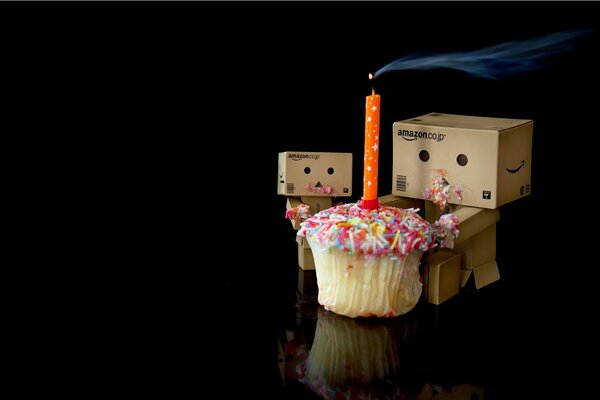 Piccoli uomini sotto forma di scatole con un cupcake festivo