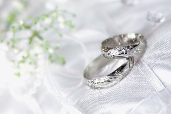 Wedding rings lying on a white cloth