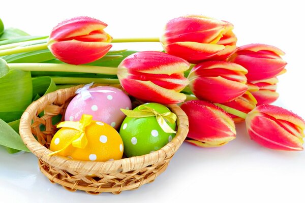 Bouquet of tulips and Easter eggs in a basket