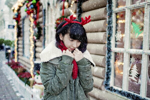 A girl on a street decorated for the holiday