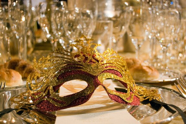 A mask on a festive table, a masquerade ball