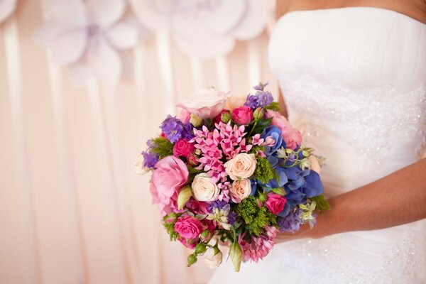 Wedding, a small cute bouquet in the hands of the bride