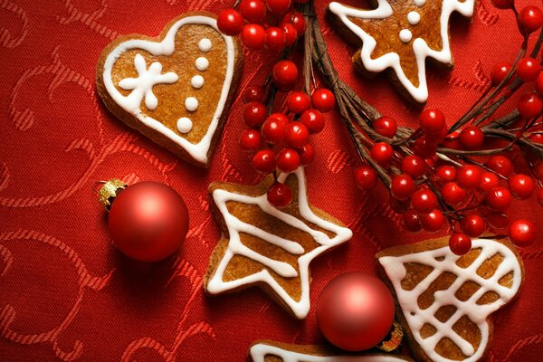 Christmas still life on a red tablecloth with cookies and balloons