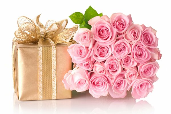 A bouquet of pink roses and a gift