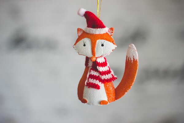 Christmas toy fox in a striped scarf