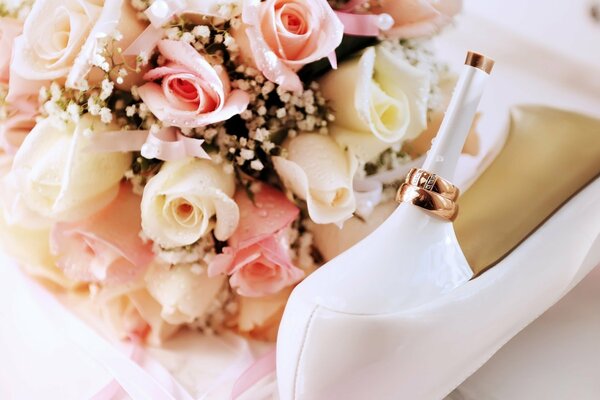 A beautiful bright bouquet next to a white slipper