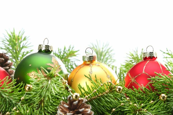 Christmas colorful balls lying in a row on fir branches