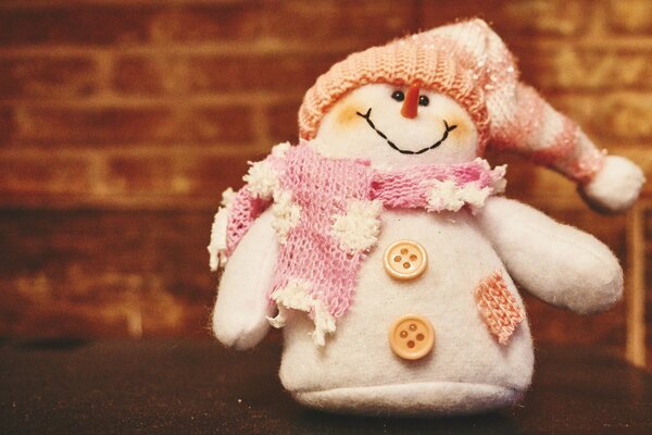 A soft snowman in a hat and scarf