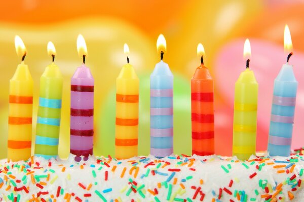 8 colorful candles in a cake for a holiday