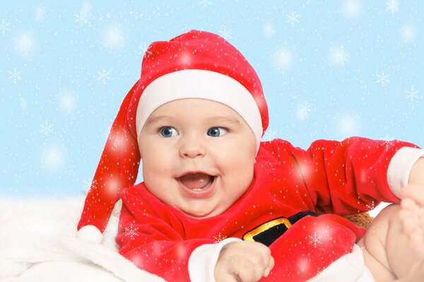 A child smiles while sitting in a Christmas costume