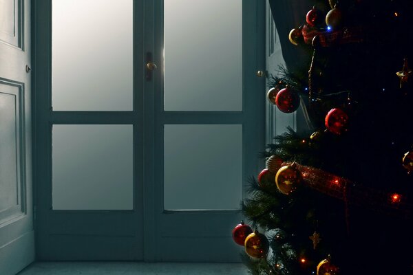 Brightly decorated Christmas tree with toys on a dim background