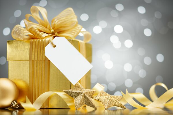 A gift in a gold package for New Year and Christmas