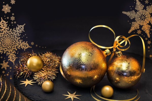 Golden Christmas balls on a black background