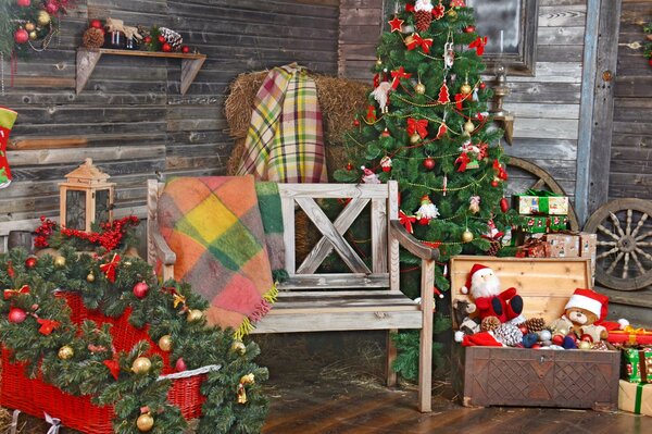 A room with antique decorations a Christmas tree and gifts