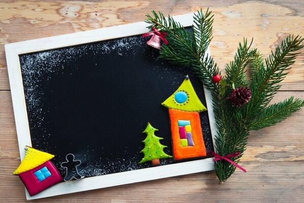 A framed house, with a pine tree on the edge