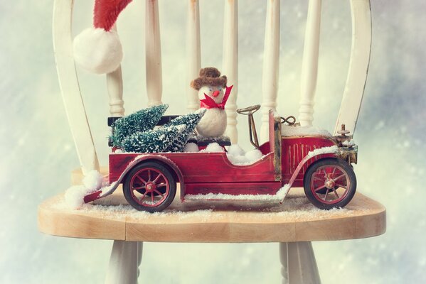 Snowman rides by car - Christmas decoration