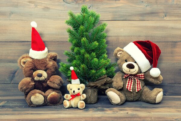 New Year bears under a fluffy Christmas tree